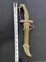 Full view of dagger in sheath beside ruler showing 14 inch length