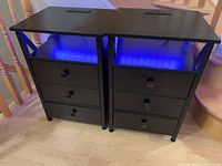 Pair of nightstands side by side showing LED shelves lit and power outlets on tops
