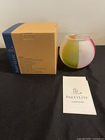 Box, one glass globe holder, pamphlet visible