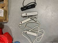 All four power strips laid out: three white, one black