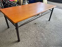Full view of coffee table showing wood top, metal legs and frame