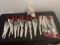 Full set of individually wrapped LED rose stems laid out on table