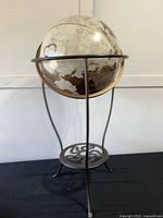 Full view of globe on metal stand