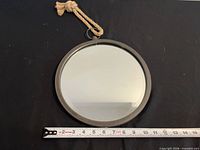 Front view of mirror with tape measure indicating diameter