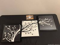 Front view of three framed art pieces displaying branch designs