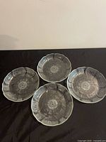 All four clear glass dessert bowls displayed top view