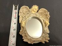 Front view with tape measure showing size of angel resin mirror