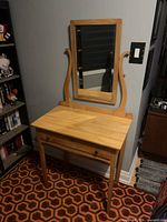 Front view of vanity table showing mirror and drawer