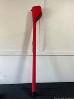 Full view of red Springbrook fishing rod case standing upright