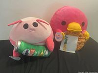 Both Squishmallows plush toys side by side displaying attached food props and tags