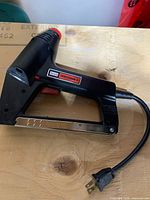 Left side view showing Craftsman branding, trigger, magazine and power cord