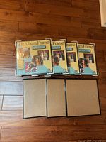 Four shrink-wrapped LP frames stacked with three unwrapped frames below