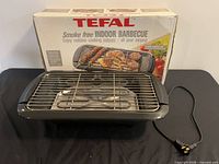 Full view of grill with power cord and box