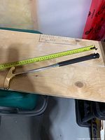 Putter collapsed beside measuring tape showing 20 inch length
