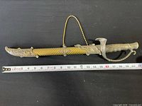 Full dagger sheathed, measuring tape showing overall length about 17 inches