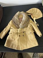 Full view of coat and hat set showing style, belt, fur collar