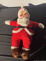Front view of Santa doll showing suit, belt, boots
