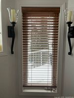 Installed brown wood blind in window