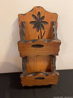 Front view showing two-tier design, carved flower, stained accents