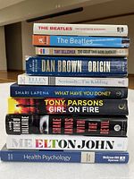 Stack of 10 books showing titles