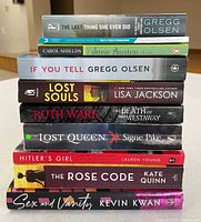 Stack of ten books showing spines and titles