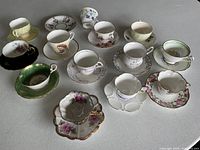 All 12 teacup and saucer sets arranged on tabletop