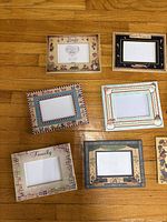 Six assorted standing photo frames with various inscriptions and borders