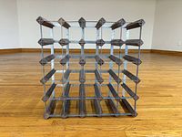 Front view showing full 5x5 grid of wood and metal wine rack