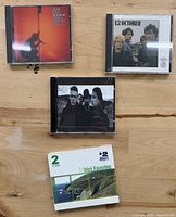 Front covers of the four CDs arranged on tabletop