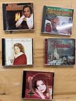 Front covers of the five Christmas CDs displayed on tabletop