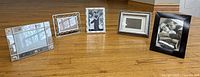 Five assorted photo frames lined up showing relative sizes and designs