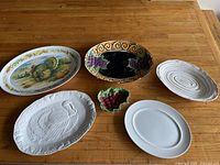 Group shot of five platters and small grape dish on table
