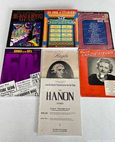 Front covers of all 7 piano books displayed