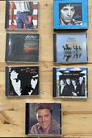 Front covers of all seven CDs arranged on tabletop