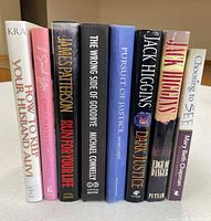 Front view of book spines showing all eight titles and formats