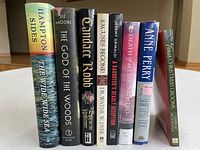 Front spines of all eight books standing upright