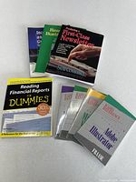 All eight reference books fanned out on tabletop, titles visible