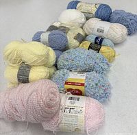 Front view showing pink sparkle skeins, blue baby clouds skeins, yellow and assorted pastel skeins