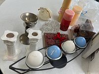 All candles and holders grouped on table