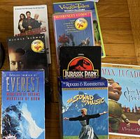 Overall view showing prerecorded VHS tapes, DVDs and spindle of blank DVDs