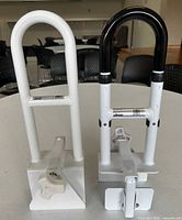 Front view showing both clamp-on bathtub rails with handles and clamp mechanisms