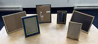 All six brass and brass-accented frames displayed upright on tabletop