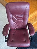 Front overhead view showing burgundy leather upholstery and padded armrests