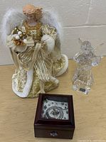 All three items together: gold angel, crystal angel, wooden music box