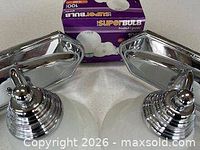 Chrome vanity fixtures with frosted glass shades and boxed bulbs