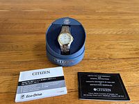 Watch displayed in Citizen Eco-Drive box with manuals and warranty booklet alongside