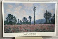 Front view of mounted Claude Monet Field of Poppies reproduction poster showing artwork, border, and publishing credit