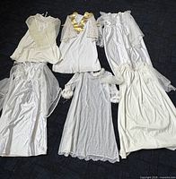 Six assorted white angel robes with lace and sheer overlays