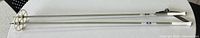 Full length view of both ski poles showing shafts, baskets and grips