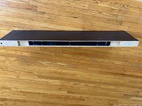 Front view of dark brown floating shelf showing length and color